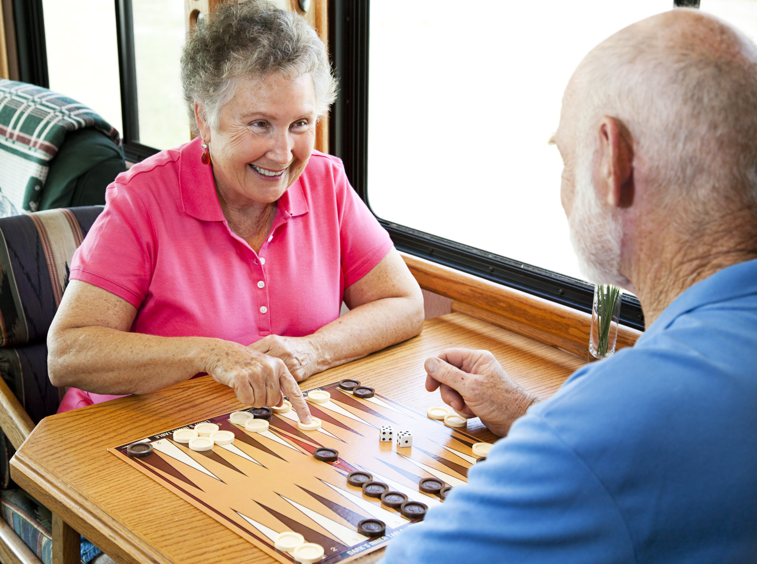 Older woman and man playing backgammon