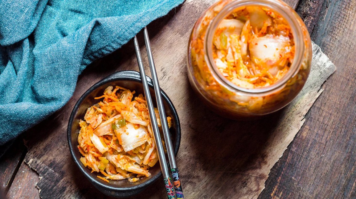 kimchi in a bowl with chopsticks